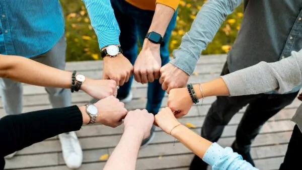 A group of people putting their hands together