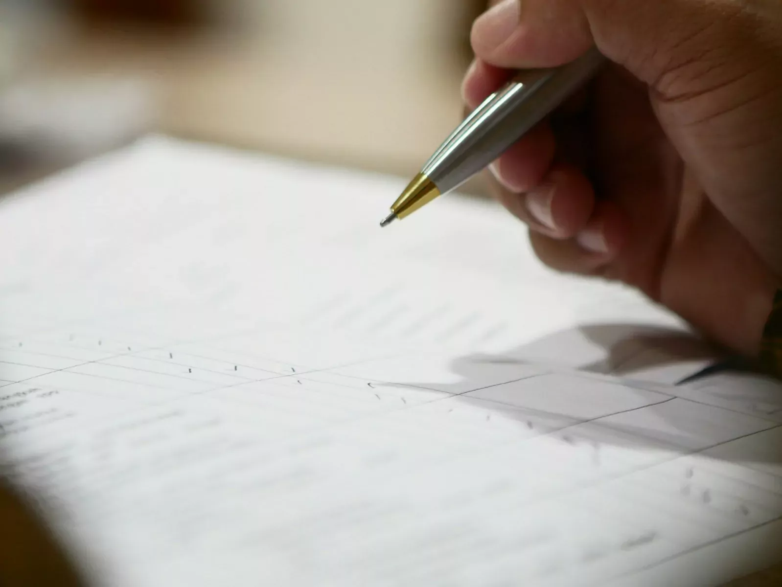 a hand holding a pen